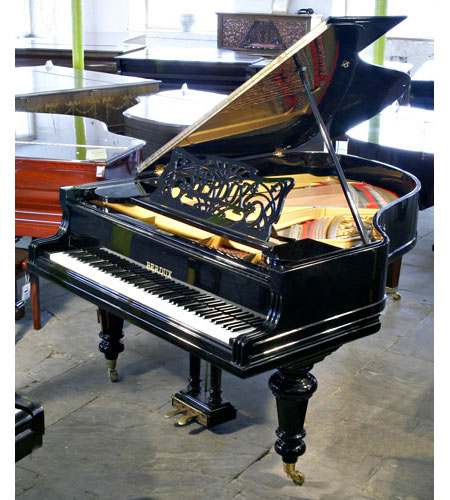 Restored, Berdux grand piano with a polished, black case and turned legs