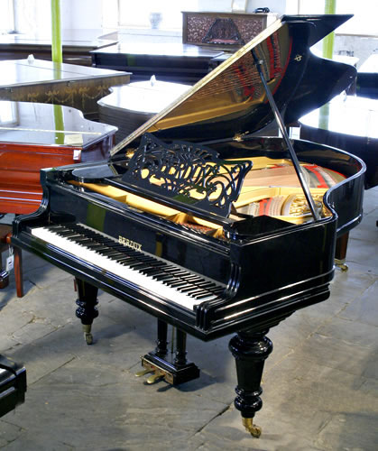 Restored, Berdux grand piano with a polished, black case and turned legs. Music desk features an art nouveau cut-out design with sinuous tendrils and the Berdux name