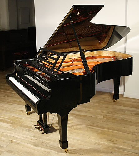 A brand new, Feurich model 218 concert grand piano with a black case and brass fittings