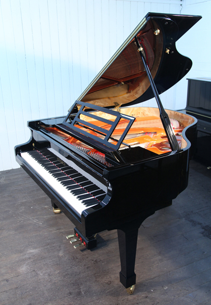 Brand new, Feurich Model 161 Professional baby grand piano with a black case and brass fittings.  Piano has an eighty-eight note keyboard and a three-pedal piano lyre. 