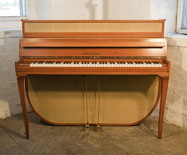 A 1955, Mid Century Modern style, Grotrian-Steinweg model 110 upright piano with a walnut case and fabric panels.. Piano has an eighty-five note keyboard and two pedals. 
