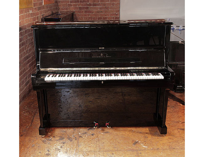 Reconditioned, 1986, Steinway Model V upright piano with a black case and brass fittings