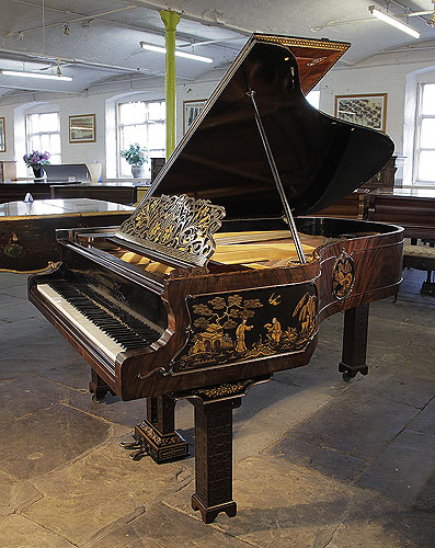 An 1899, Chinese Chippendale style, Schiedmayer grand piano for sale with a flame mahogany case and Malborough legs with applied fret carvings. Cabinet features Chinese scenes in embossed Japanning with gilt ornament.  Piano has an eighty-five note keyboard and a two-pedal lyre. 
