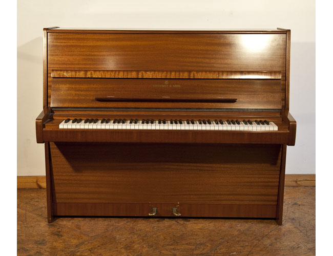 A 1975, Steinway Model V upright piano with a polished, mahogany case. Piano has an eighty-eight note keyboard and two pedals. 