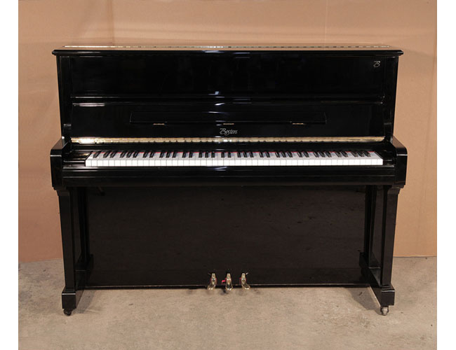 Reconditioned, 2004, Boston UP-118 upright piano for sale with a black case and brass fittings. Piano has an eighty-eight note keyboard and three pedals. 