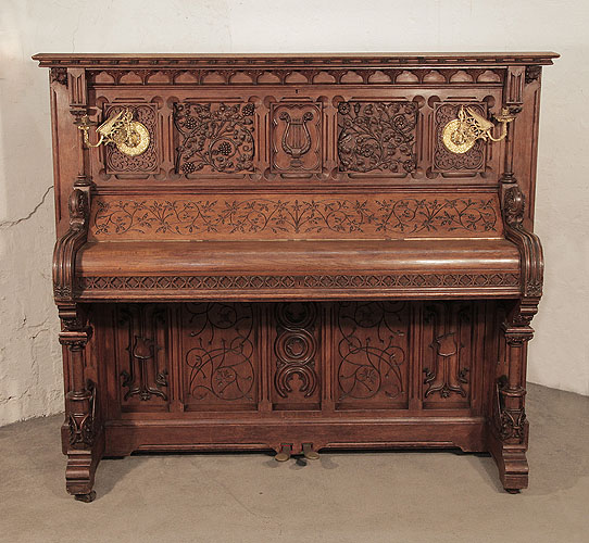 Renaissance style, Gebruder Knake upright piano for sale with an ornately carved, oak case. Cabinet features front panels carved with arabesque style, flowers, foliage 