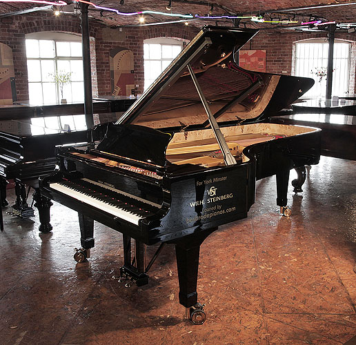 Brand new, Wilh Steinberg WS-D275 concert grand piano with a black case and brass fittings. Piano has an eighty-eight note keyboard and three-pedal lyre. This concert grand piano has been in residency for the past year at York Minster throughout its once-a-century organ renovation project.