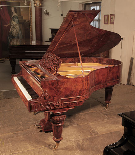 Restored, Schiedmayer grand piano for sale with a french polished, burr walnut cabinet  and turned, faceted legs.  The serpentine piano cheek features carvings of scrolling foliage and spirals. Piano has an eighty-five note keyboard and a two-pedal lyre.
