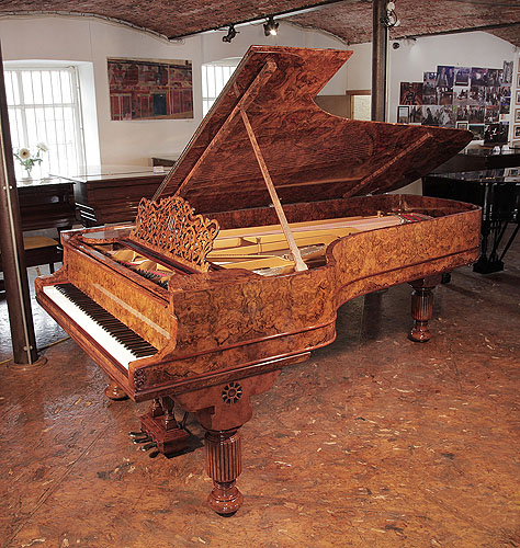 Rebuilt, 1881, Steinway & Sons Model D concert grand piano with an exquisite, burr walnut case and  fluted, barrel legs. Piano has an eighty-eight note keyboard and a three-pedal lyre.