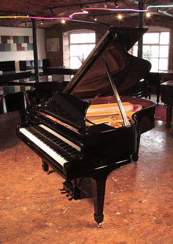 Rebuilt, 1932, Steinway Model M grand piano for sale with a black case and spade legs. Piano has an eighty-eight note keyboard and a two-pedal lyre. 