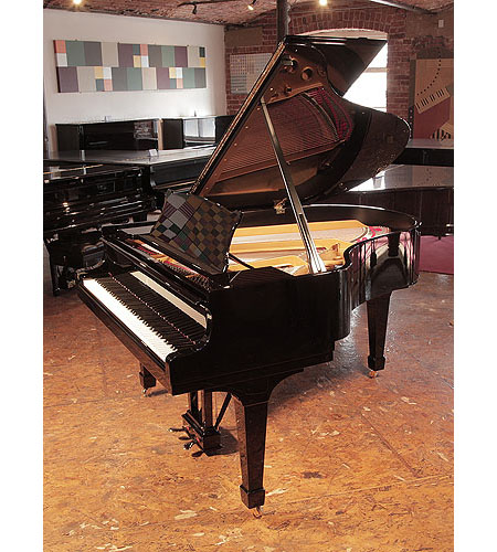 Rebuilt, 1956, Steinway Model M grand piano for sale with a black case and spade legs.  Piano has an eighty-eight note keyboard and a two-pedal lyre. 