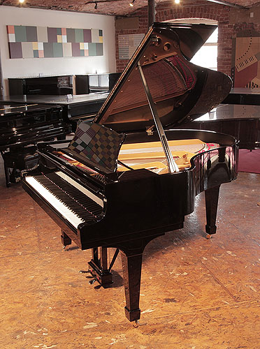 Rebuilt, 1956, Steinway Model M grand piano for sale with a black case and spade legs.  Piano has an eighty-eight note keyboard and a two-pedal lyre. 