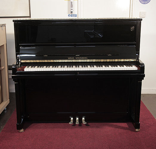 Piano for sale. Brand new, Wilh. Steinberg Model AT-K30 upright piano with a black case and brass fittings. Piano features a walnut key block and slow fall mechanism. Piano has an eighty-eight note keyboard and three pedals.