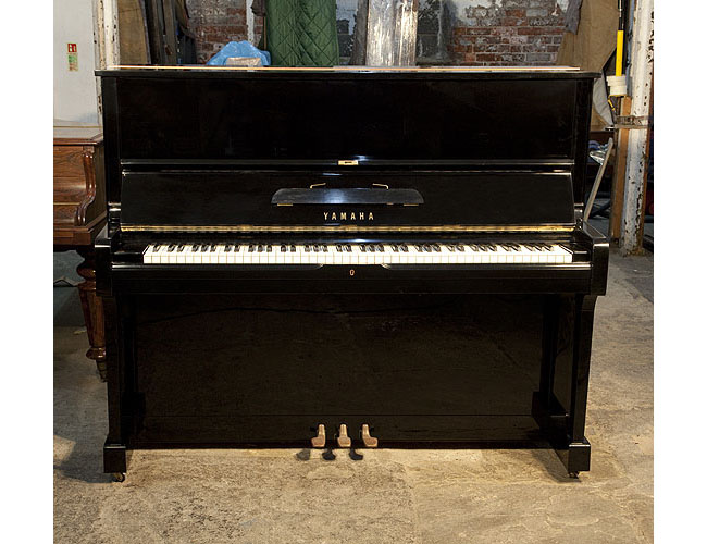 Reconditioned, 1974, Yamaha U1 upright piano with a black case and polyester finish. Piano has an eighty-eight note keyboard and three pedals.