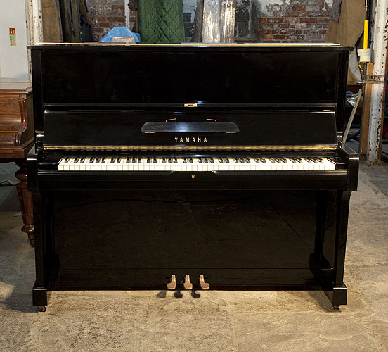  Reconditioned, 1974, Yamaha U1 upright piano with a black case and polyester finish. Piano has an eighty-eight note keyboard and three pedals.