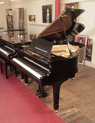 Reconditioned, 1978, Yamaha G2 grand piano for sale with a black case and spade legs. Piano has an eighty-eight note keyboard and a two-pedal lyre. 