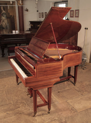 A 1910, Collard and Collard baby grand piano with a mahogany case and gate legs attached with a cross stretcher. Piano has an eighty-five note keyboard and a two-pedal lyre.