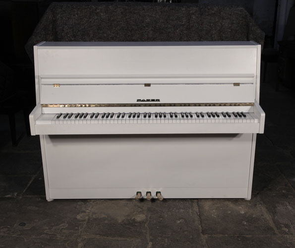 Pre-owned, Fazer upright piano for sale with a matt, white case and brass fittings. Piano has an eighty-eight note keyboard and and three pedals 