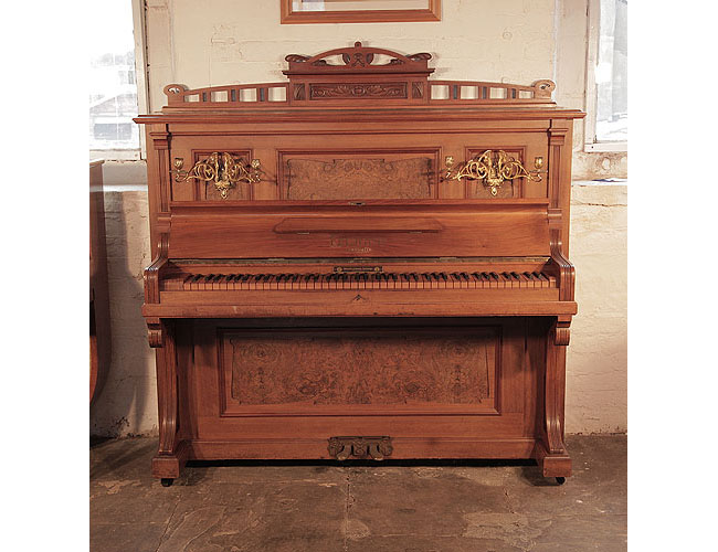 Antique, 1908, Feurich upright piano with a walnut case, burr walnut panels and an unusual walnut keyboard Piano has an eighty-five note keyboard and two pedals. 