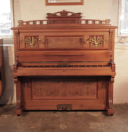 Reconditioned, 1908, Feurich upright piano with a walnut case, burr walnut panels and an unusual walnut keyboard Piano has an eighty-five note keyboard and two pedals. 
