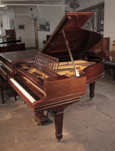 Antique, 1900, Steinway Model A grand piano with a polished, rosewood case and spade legs. The cut-out music desk is in a geometric design featuring interlocking ovals.  Piano has an eighty-eight note keyboard and a three-pedal lyre.