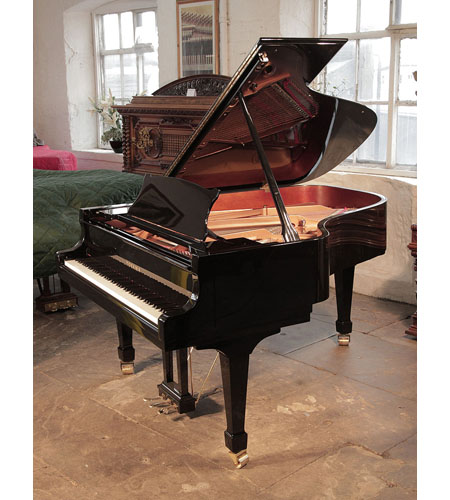  Toyama TC-187 grand piano for sale with a black case and spade legs.  Piano has an eighty-eight note keyboard and a two-pedal lyre. 