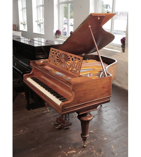 Rebuilt, 1914, Chappell baby grand piano with a polished, mahogany case and turned legs. Piano has an eighty-five note keyboard and a two-pedal lyre. 