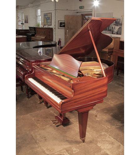  Restored, 1933, Bechstein Model K baby grand piano with a polished, mahogany case and square, tapered legs. Piano has an eighty-eight note keyboard and a two-pedal lyre.