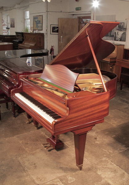 Restored, 1933, Bechstein Model K baby grand piano with a polished, mahogany case and square, tapered legs. Piano has an eighty-eight note keyboard and a two-pedal lyre. 