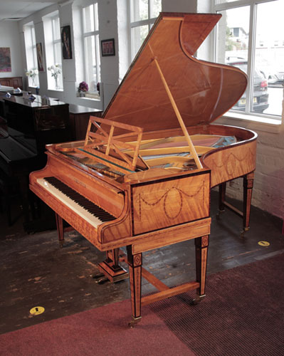 Restored, 1910, Bechstein Model B grand piano with a book-matched, satinwood case with boxwood stringing. Piano has gate legs attached with a cross stretcher. Entire cabinet inlaid with swagged bellflowers and bows.