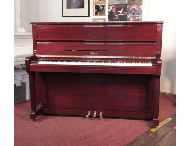 Reconditioned, 1999,  Boston UP-118E upright piano for sale with a mahogany gloss case and brass fittings.. Piano has an eighty-eight note keyboard and three pedals.  
