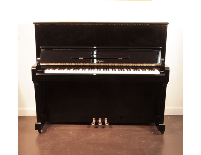Reconditioned, 1999, Boston UP-125E upright piano with a black case and brass fittings. Piano designed by Steinway. Piano has an eighty-eight note keyboard and three pedals.  