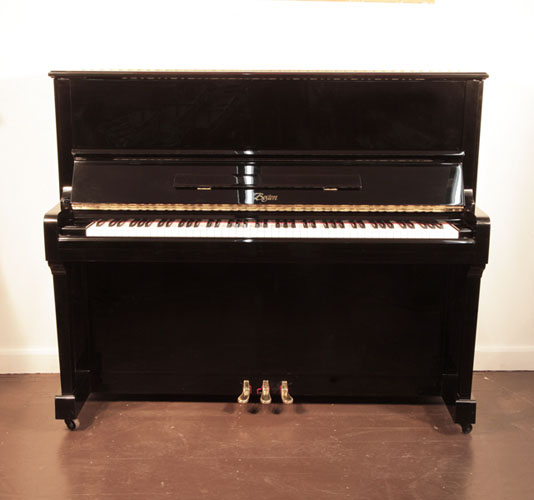 Reconditioned, 1999, Boston UP-125E upright piano with a black case and brass fittings. Piano designed by Steinway. Piano has an eighty-eight note keyboard and three pedals. 