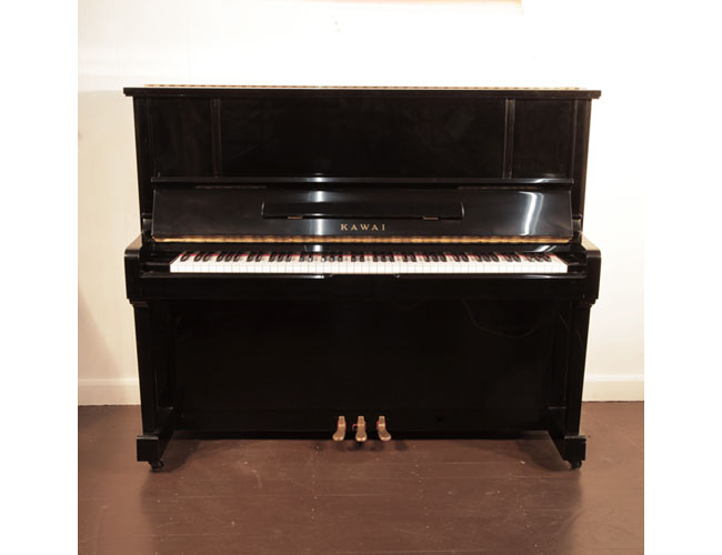 Reconditioned, 1991, Kawai BS-25 upright piano with a black case and polyester finish. Piano has an eighty-eight note keyboard and three pedals.  
