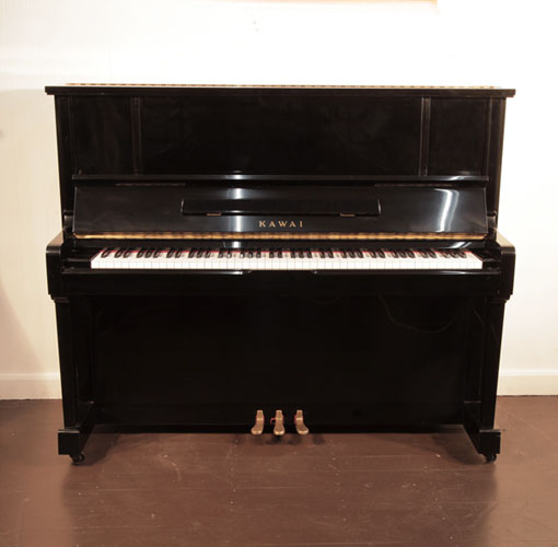 Piano for sale. Reconditioned, 1991, Kawai BS-25 upright piano with a black case and polyester finish. Piano has an eighty-eight note keyboard and three pedals. 