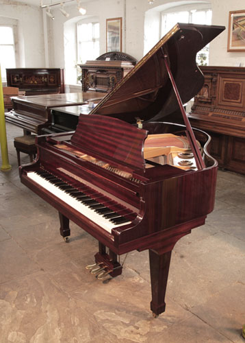 Reconditioned, 1986, Kawai KG-1D baby grand piano with a mahogany case and spade legs. Piano has an eighty-eight note keyboard and a three-pedal lyre