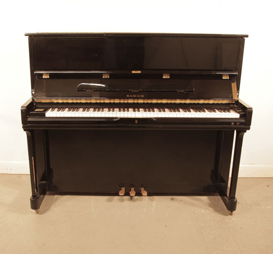 Reconditioned, 1996, Samick SU121SP upright piano with a black case and polyester finish. Piano has an eighty-eight note keyboard and three pedals.