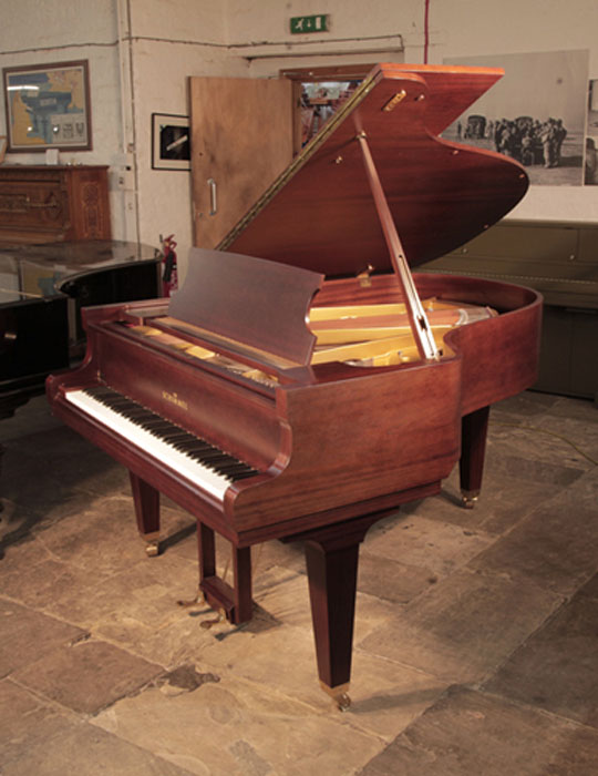 Reconditioned, 1987, Schimmel grand piano for sale with a mahogany case and square, tapered legs. Piano has an eighty-eight note keyboard and a two-pedal lyre. .
