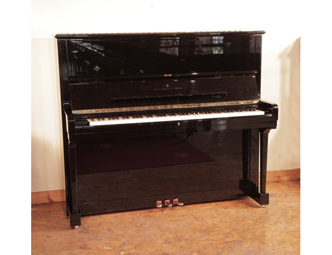 Reconditioned, 1990, Steinway Model K upright piano for sale with a black case and brass fittings. Piano has an eighty-eight note keyboard and three pedals. Piano features a third sostenuto pedal. 