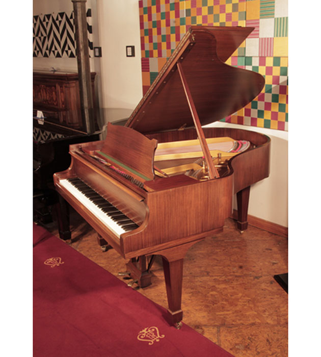 Restored,  1961, Steinway Model M grand piano with a satin, walnut case and spade legs.  Piano has an eighty-eight note keyboard and a two-pedal lyre.  