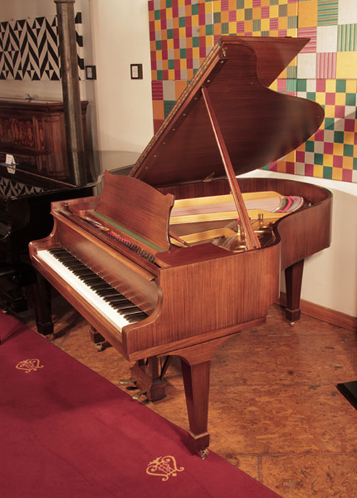 Restored 1961, Steinway Model M grand piano with a satin, walnut case and spade legs. Piano has an eighty-eight note keyboard and a two-pedal lyre 