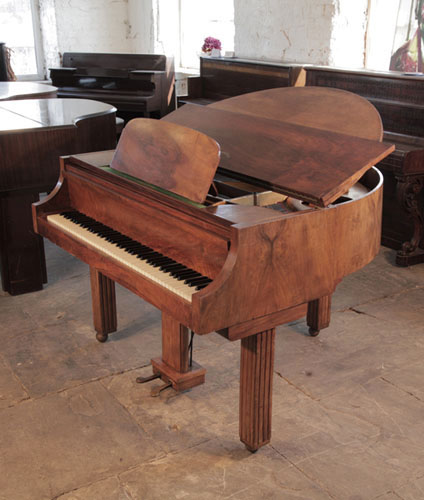 Art Deco style Strohmenger baby grand piano with a walnut case. Piano Legs amd lyre feature strong geometric styling