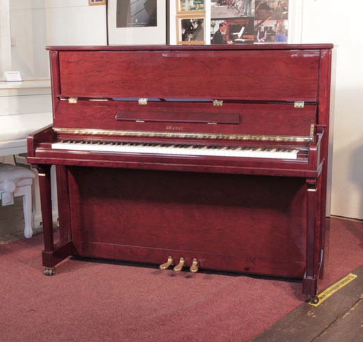 Reconditioned, 2010,  Weber TU-122S upright piano for sale with a mahogany gloss case and brass fittings. Piano has an eighty-eight note keyboard and and three pedals. 