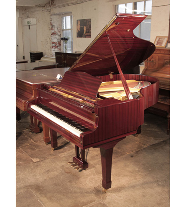 Reconditioned, 1987, Yamaha C3 grand piano for sale with a mahogany case and spade legs. Piano has an eighty-eight note keyboard and a three-pedal lyre. 
