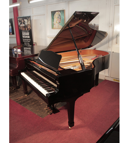 Reconditioned, 2000, Yamaha C6 grand piano for sale with a black case and spade legs. Piano has an eighty-eight note keyboard and a three-pedal lyre. 