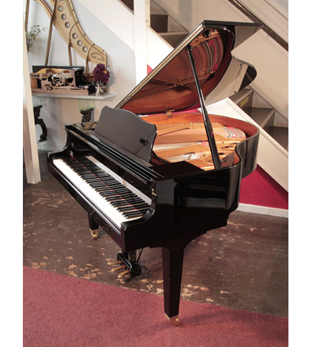  Reconditioned, 2009, Yamaha GB1 baby grand piano with a black case and square, tapered legs. Piano has an eighty-eight note keyboard and a three-pedal lyre.