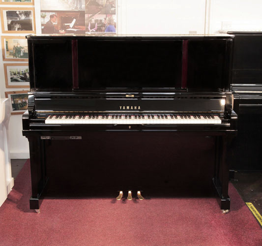 A 2019, Yamaha YUS5 SH2 upright piano for sale with a black case and brass fittings. Piano has a fitted silent system. Condition as new. Piano has an eighty-eight note keyboard and three pedals.  