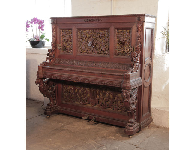 Biese Hof upright piano for sale with an ornately carved, oak case and griffin legs