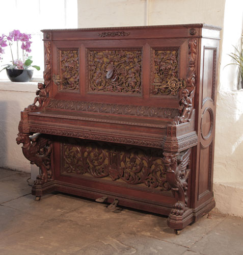 Biese Hof upright piano for sale with an ornately carved, oak case and griffin legs