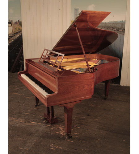 A 1927, Bluthner with a polished, rosewood case. Music desk is in an openwork geometric design